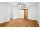 Bedroom with a ceiling fan, closet and a bathroom with a sliding wood door and wood-look flooring at 901 Gettysburg Pl, Atlanta, GA 30350