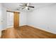 Bedroom with a ceiling fan and wood-look floors, plus access to an adjacent bathroom at 901 Gettysburg Pl, Atlanta, GA 30350