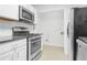 Bright kitchen featuring stainless steel appliances and white cabinetry at 901 Gettysburg Pl, Atlanta, GA 30350