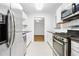 Modern kitchen with stainless steel appliances, white cabinets, and tile flooring at 901 Gettysburg Pl, Atlanta, GA 30350