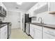 Well-lit kitchen featuring stainless steel appliances and modern countertops and white cabinets at 901 Gettysburg Pl, Atlanta, GA 30350