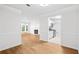 Open-concept living area leading to a kitchen with hardwood floors and neutral decor at 901 Gettysburg Pl, Atlanta, GA 30350