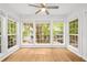 Bright living room with large windows and natural light, ceiling fan, and hardwood floors at 901 Gettysburg Pl, Atlanta, GA 30350