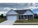Charming one-story home with brick and white siding, complemented by a well-manicured front lawn at 911 Park Place St, Social Circle, GA 30025