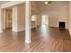 Open-concept living room with wood floors, a fireplace, and abundant natural light at 911 Park Place St, Social Circle, GA 30025