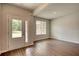 Bright living room with hardwood floors, a double-door entry, and natural light streaming through the windows at 911 Park Place St, Social Circle, GA 30025