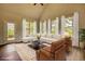 Bright living room with vaulted ceiling, expansive windows, and comfortable seating arrangement at 911 Park Place St, Social Circle, GA 30025