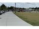 Well-maintained community area with pedestrian walkways, a lawn, public art, and parking for residents and visitors at 269 Privet Cir, Suwanee, GA 30024