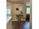 Elegant hallway with swan console table, artwork, and windows overlooking the greenery at 269 Privet Cir, Suwanee, GA 30024