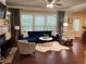 Beautiful living room with fireplace and plenty of natural light with hardwood flooring at 269 Privet Cir, Suwanee, GA 30024