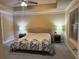 Comfortable bedroom boasts tray ceilings, neutral carpet, and ample natural light from a window at 269 Privet Cir, Suwanee, GA 30024