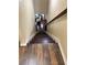 View of wooden stairs leading to a living area with a white chair and a glimpse of the outside at 269 Privet Cir, Suwanee, GA 30024