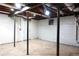 Spacious unfinished basement with visible pipes, beams, and a single door leading outside at 875 Eleanor Nw Ct, Atlanta, GA 30318
