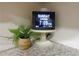 A digital clock showing date and time sits on a granite countertop next to a small plant at 875 Eleanor Nw Ct, Atlanta, GA 30318