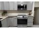 Well-lit kitchen with gray cabinets, stainless steel appliances, and granite countertops at 875 Eleanor Nw Ct, Atlanta, GA 30318