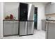 Modern kitchen with stainless steel refrigerator and sleek gray cabinets with light granite countertops at 875 Eleanor Nw Ct, Atlanta, GA 30318