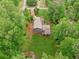An aerial view of a well-maintained home with a lush backyard, surrounded by mature trees for optimal privacy at 1675 Commonwealth Trl, Cumming, GA 30041