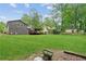 Beautiful backyard with a well-maintained lawn, privacy fence, mature trees, and a covered deck at 1675 Commonwealth Trl, Cumming, GA 30041