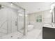 Modern bathroom featuring glass enclosed shower, soaking tub, dual sinks, and marble tile at 1675 Commonwealth Trl, Cumming, GA 30041