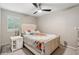 Cozy bedroom with a queen-size bed, plush carpet, and a ceiling fan at 1675 Commonwealth Trl, Cumming, GA 30041