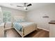 Light and airy bedroom features hardwood floors, a ceiling fan, and a window for natural light at 1675 Commonwealth Trl, Cumming, GA 30041