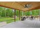 Spacious covered deck with an outdoor dining area and wooded view at 1675 Commonwealth Trl, Cumming, GA 30041