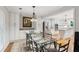 Dining room with glass table, decorative chandelier, and access to modern kitchen at 1675 Commonwealth Trl, Cumming, GA 30041