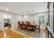 Elegant dining room featuring hardwood floors, ample lighting, and a spacious table with seating for eight at 1675 Commonwealth Trl, Cumming, GA 30041