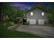 Charming two-story home with a gray shingle exterior and a two-car garage and a nice lawn at 1675 Commonwealth Trl, Cumming, GA 30041