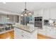 Well-lit kitchen features a central island, granite countertops, and stainless steel appliances at 1675 Commonwealth Trl, Cumming, GA 30041