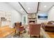 Comfortable living room with a stone fireplace, hardwood floors, and views of the modern kitchen at 1675 Commonwealth Trl, Cumming, GA 30041