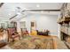 Bright and spacious living area with a stone fireplace, hardwood floors, and a view to the kitchen at 1675 Commonwealth Trl, Cumming, GA 30041