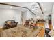 Cozy living room showcasing hardwood floors, wooden beams, and an open layout to the dining area at 1675 Commonwealth Trl, Cumming, GA 30041