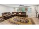 Spacious living room with a large sectional sofa, ceiling fan, and a decorative rug at 1675 Commonwealth Trl, Cumming, GA 30041