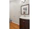 Modern powder room with wood floors, a new cabinet, and sleek mirror at 1675 Commonwealth Trl, Cumming, GA 30041