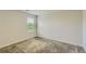 Bright bedroom with neutral walls, carpeted floors, and a window inviting natural light at 229 Prescott St, Locust Grove, GA 30248