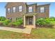 Inviting front entrance of home with a brick facade and trimmed greenery at 229 Prescott St, Locust Grove, GA 30248