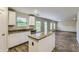 Open kitchen with granite counters and an island flows into the living room at 229 Prescott St, Locust Grove, GA 30248