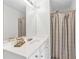 Modern bathroom with a large mirror, white vanity, and a shower with a stylish gray curtain at 3562 Greenwich Ave, Duluth, GA 30096