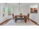 Cozy dining room with a wood table, bench seating, and a view of the well-landscaped backyard at 3562 Greenwich Ave, Duluth, GA 30096