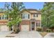 Charming townhouse with a well-manicured lawn, garage and traditional architectural details at 3562 Greenwich Ave, Duluth, GA 30096