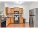 Efficient kitchen featuring stainless steel appliances, wood cabinets, and sleek granite countertops at 3562 Greenwich Ave, Duluth, GA 30096
