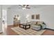 Inviting living room with hardwood floors, neutral decor, comfortable seating, and lots of natural light at 3562 Greenwich Ave, Duluth, GA 30096