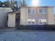 Two-story apartment building with beige siding, private entry, and manicured shrubs at 3575 Oakvale Road # 303, Decatur, GA 30034