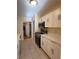Modern kitchen with white cabinets, stainless steel appliances, and tiled floor at 3575 Oakvale Road # 303, Decatur, GA 30034