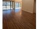 Open-concept living area with hardwood floors and sliding glass doors leading to balcony at 3575 Oakvale Road # 303, Decatur, GA 30034