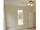 Bedroom features a ceiling fan, a window, and a door, offering a relaxing space at 3592 Galdway Dr, Snellville, GA 30039