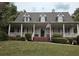Charming single Gathering home featuring a wide front porch and well manicured front yard and inviting curb appeal at 3592 Galdway Dr, Snellville, GA 30039