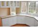 Bright kitchen with white cabinets, wood floors, and large windows offering natural light at 3592 Galdway Dr, Snellville, GA 30039