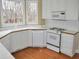 Bright kitchen with white cabinets, modern appliances, and natural light from the bay window at 3592 Galdway Dr, Snellville, GA 30039